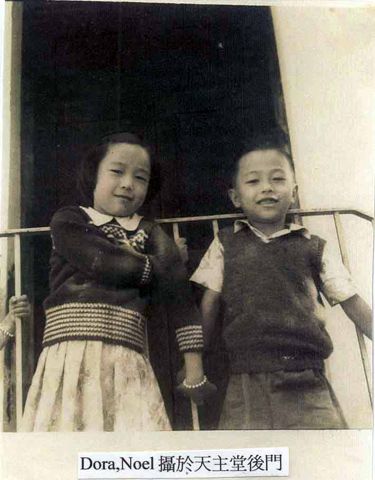 Regina's children. Dora (left) and Noel at the back entrance of the church