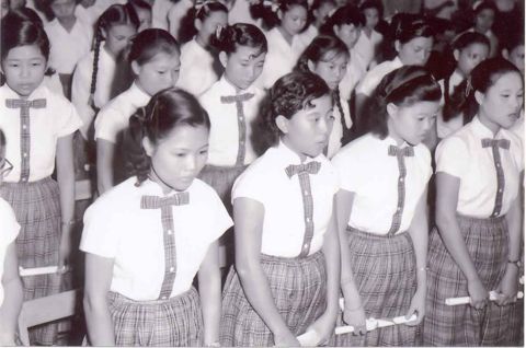 Students holding certificates at graduation