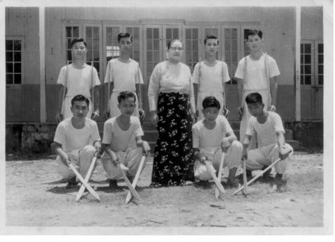 Kenneth Law with teacher and classmates
