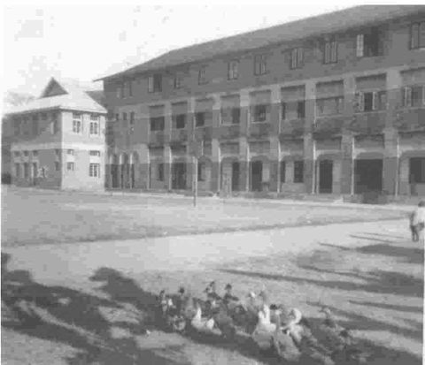 The building on the right housed an administrative office and classrooms on the ground flo