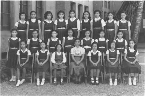 Maisie with teacher and classmates