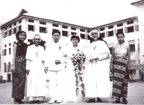 Newly-wed couple with nuns and teachers